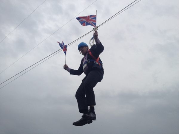 London Mayor Boris Johnson gets stuck waving Union Flags from a zipwire in East London