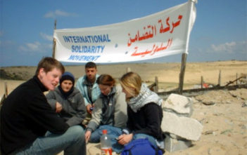 Rachel Corrie (right) defending a Palestinian well
