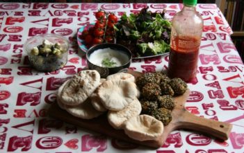 Mezze with falafel, pittas, olives, and salad