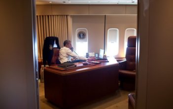 President Obama takes a phone call aboard Air Force One