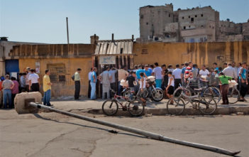 People queue to buy bread in Aleppo, Syria