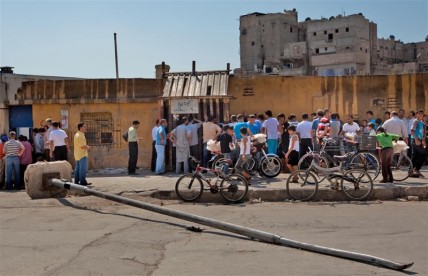 People queue to buy bread in Aleppo, Syria