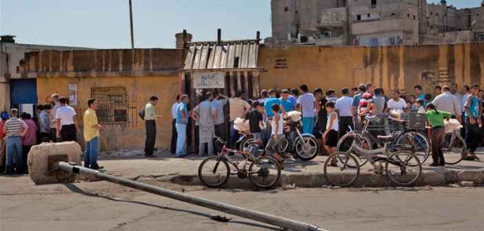 People queue to buy bread in Aleppo, Syria