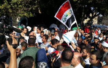 Protesters burn Israeli flag outside the Arab League offices in Tahrir