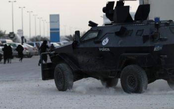 Female protesters flee from armoured police vehicle