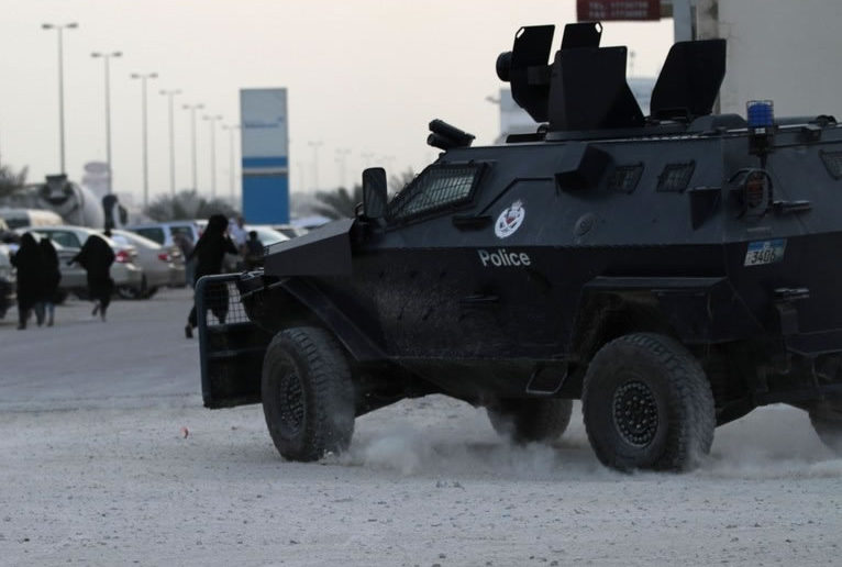 Female protesters flee from armoured police vehicle