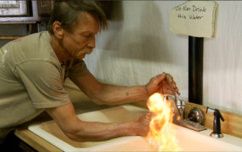 Still from the documentary Gasland (2010) that shows flammable "water" coming from a tap in a fracking area