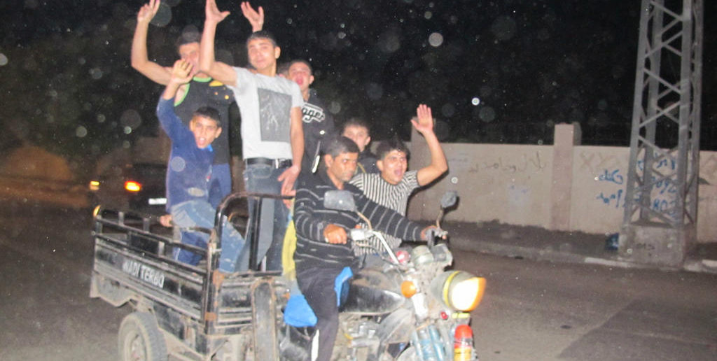 Boys race through Gaza City celebrating the ceasefire