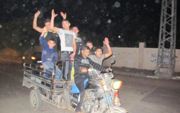 Boys race through Gaza City celebrating the ceasefire