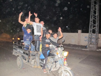 Boys race through Gaza City celebrating the ceasefire