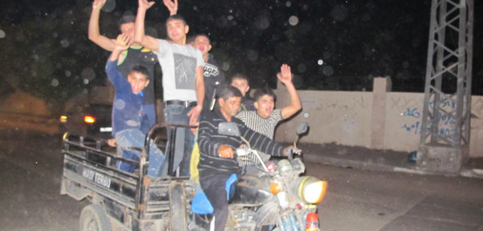 Boys race through Gaza City celebrating the ceasefire