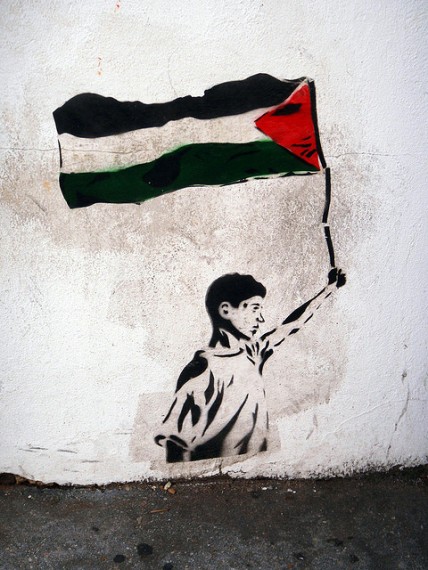 Graffiti of boy holding Palestinian flag