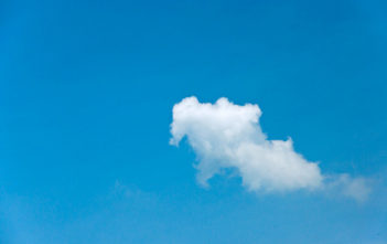 Single white cloud on a clear blue sky
