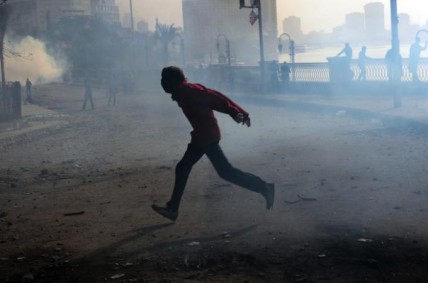 A protestor runs from tear gas in Egypt