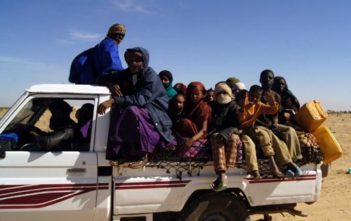 People of northern Mali drive through the desert