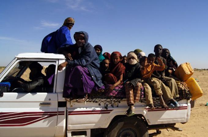 People of northern Mali drive through the desert