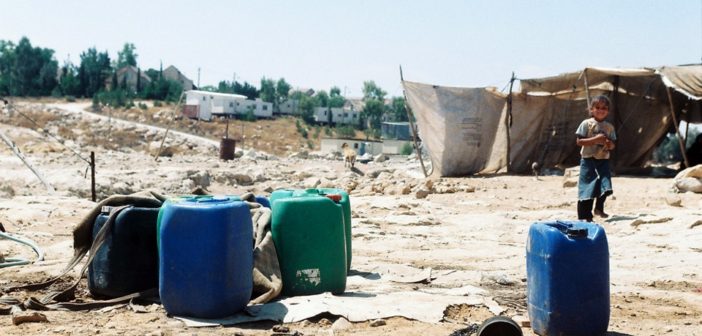 Carmel settlement can be seen in the background of Um al-Khair village in the West Bank