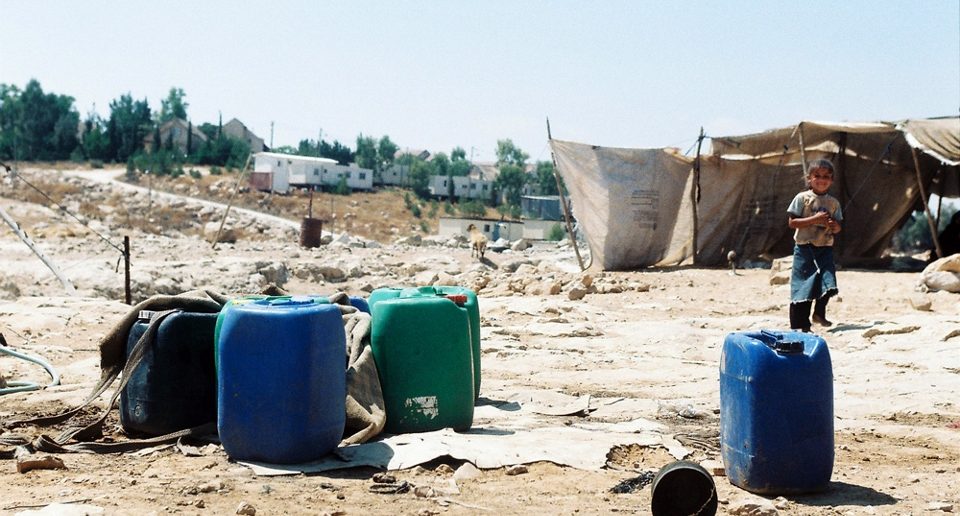 Carmel settlement can be seen in the background of Um al-Khair village in the West Bank
