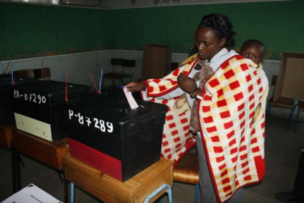 A voter casts her ballot in the 2013 Kenyan election