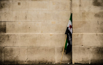 Syria freedom flag by a wall