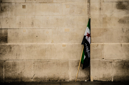 Syria freedom flag by a wall
