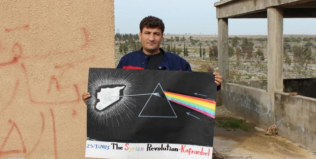 Raed Fares with a poster paying homage to Pink Floyd’s Dark Side of the Moon