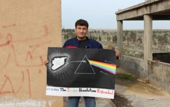 Raed Fares with a poster paying homage to Pink Floyd’s Dark Side of the Moon