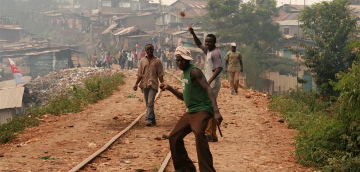 Rowdy youth throw stones in Kibera slums, Nairobi; Kenya