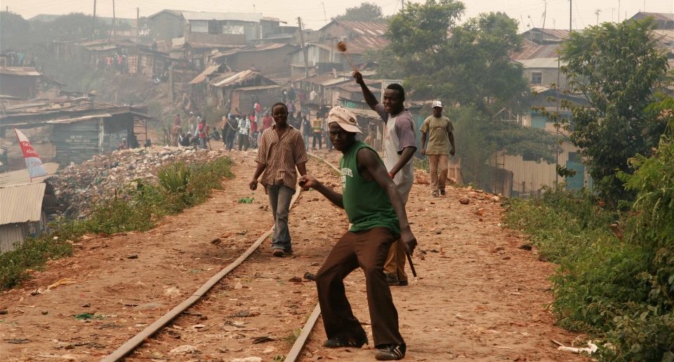 Rowdy youth throw stones in Kibera slums, Nairobi; Kenya