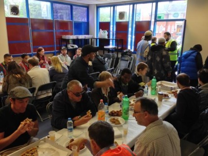 People sit down to somosas and pizza at the Lewisham Islamic Centre