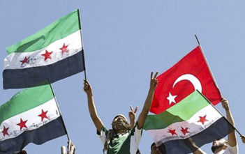 Syrian refugees wave Turkish and Syrian Independence flags