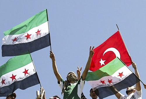Syrian refugees wave Turkish and Syrian Independence flags