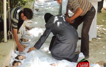 Man carries his child, killed in the chemical attack in Ghouta, Syria