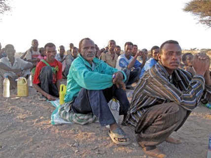 Migrants queue before being smuggled from Obock, Djibouti to Yemen