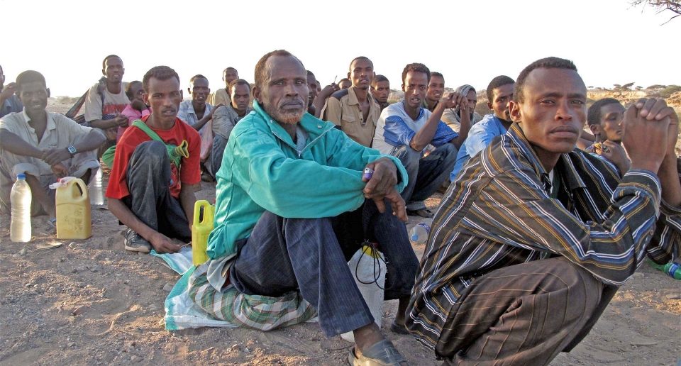 Migrants queue before being smuggled from Obock, Djibouti to Yemen