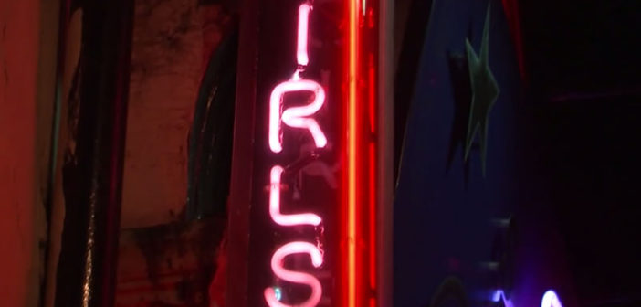 Neon signs for strip clubs in Soho, London