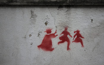 Graffiti on a wall in Lisbon depicting a priest chasing two children, denouncing the child abuse scandal that rocked the catholic churchGraffiti on a wall in Lisbon depicting a priest chasing two children, denouncing the child abuse scandal that rocked the Catholic Church