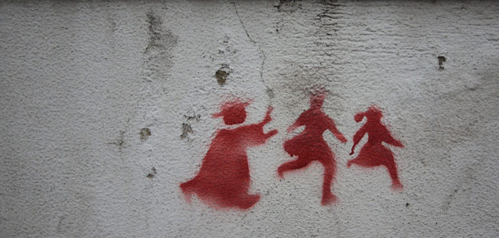 Graffiti on a wall in Lisbon depicting a priest chasing two children, denouncing the child abuse scandal that rocked the catholic churchGraffiti on a wall in Lisbon depicting a priest chasing two children, denouncing the child abuse scandal that rocked the Catholic Church