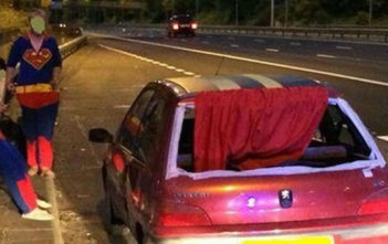 Supermen with red-caped car pulle dover by police