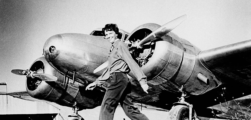 Amelia Earhart with a Lockhead Electra aircraft (1937)