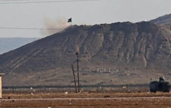 Islamic State flag on hill near Kobane