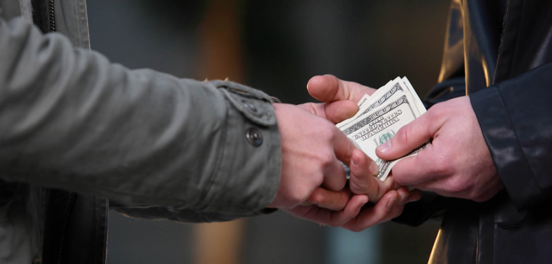 Money changing hands (Shutterstock)