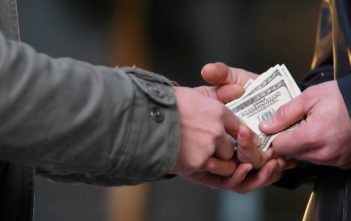 Money changing hands (Shutterstock)