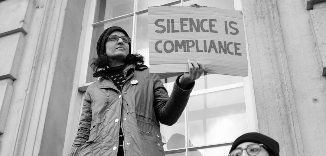 "Silence is compliance" anti-Trump protest sign