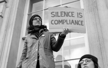 "Silence is compliance" anti-Trump protest sign