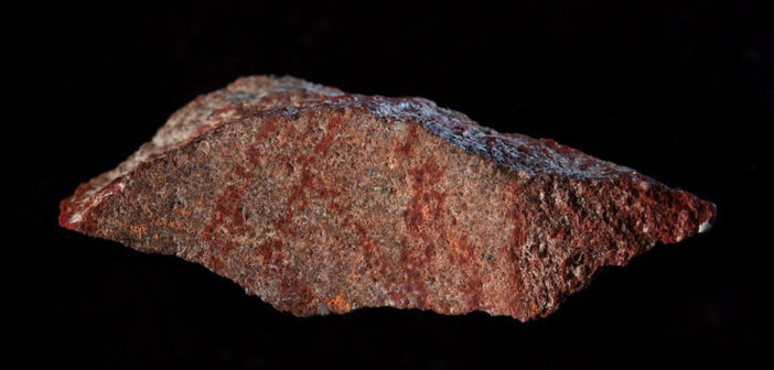 The drawing found on silcrete stone in Blombos Cave